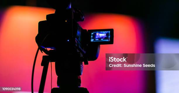 Silhouette Of A Tv Camera Filming A Live Broadcast Stock Photo - Download Image Now - Live Streaming, Camera Operator, Broadcasting