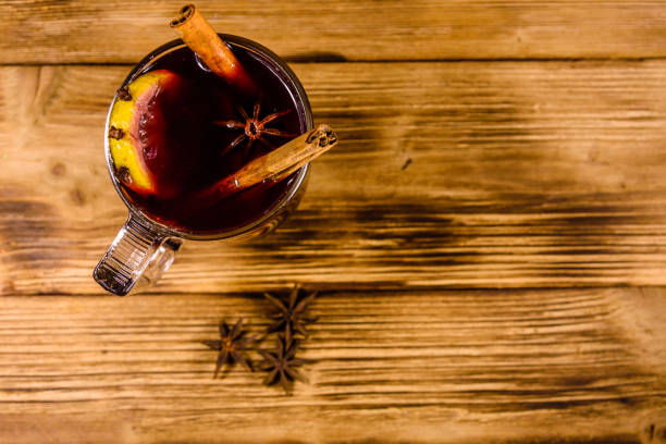istock Cup of mulled wine with cinnamon on wooden table. Top view 1090035234