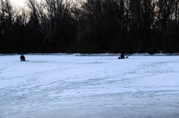 istock Winter fishing on a frozen river 1090036322