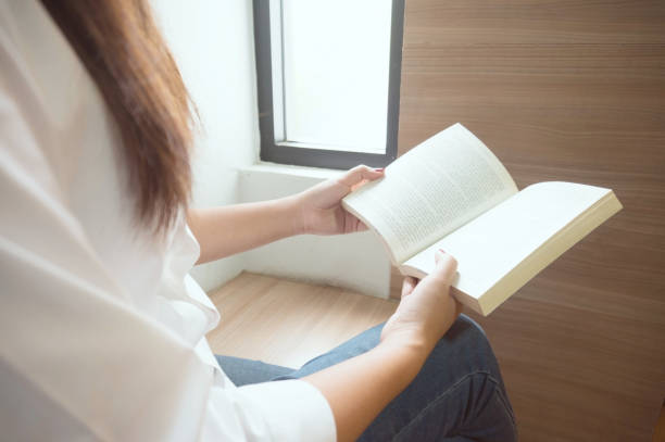 istock Women reading book and relaxing in library. selective focus 1090037280