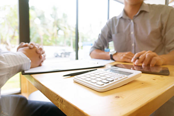 istock Businessman analyzing investment charts and pressing calculator buttons over documents. Accounting Concept. 1090046382