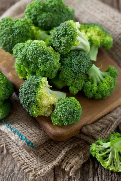 fresh broccoli on wooden surface