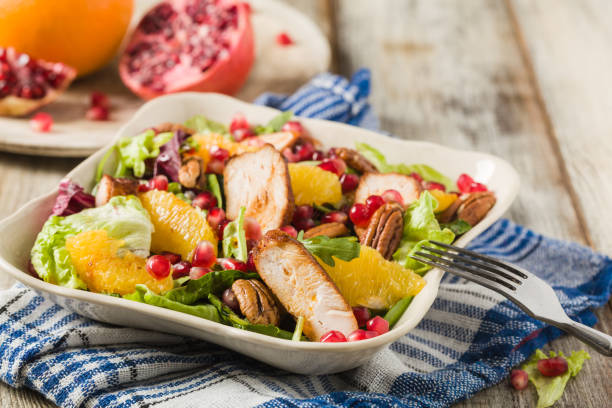 istock Spring salad with chicken, pomegranate, orange, pecan nuts and honey. 1090064950