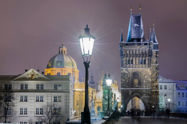 Charles Bridge in Prague The snowy night view of Charles Bridge in Prague. long exposure winter crowd blurred motion stock pictures, royalty-free photos & images