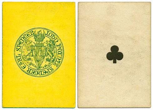 Antique 19th century playing card with a yellow and green symbol back pattern that features the coat of arms of John Poyntz Spencer, the 5th Earl Spencer (born 1835). Motto in French: Dieu defend le droit. This card is an ace of clubs, featuring a crude club symbols The card has no indices (no numbers) at top and bottom.