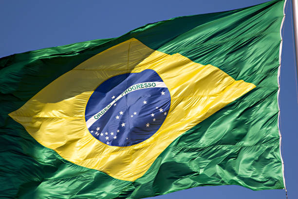 istock Flag of Brazil on blue sky 1090071974