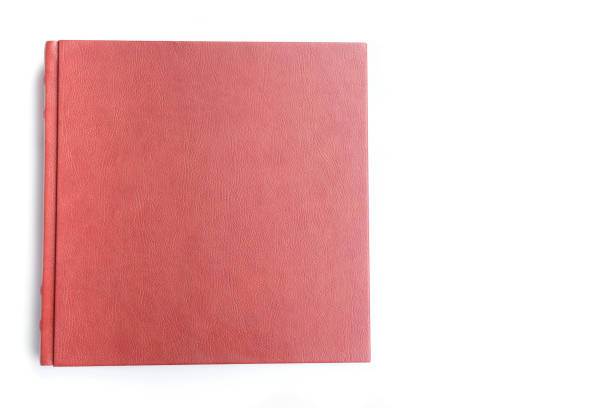 istock Red leather covered wedding album lie on white background. 1090080390
