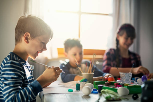 istock Brother and sister painting Easter eggs 1090080596