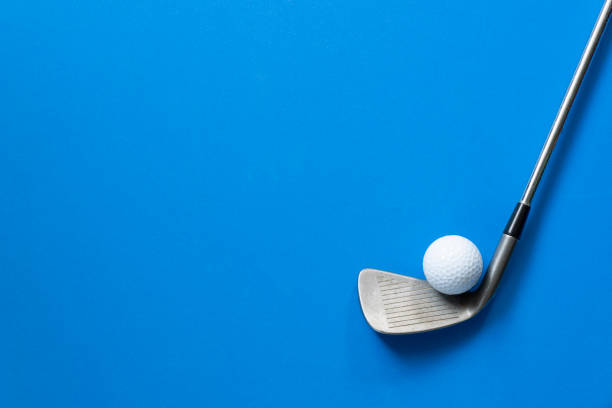 istock golf ball and golf club on blue background 1090084482