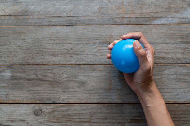 istock Hands of a woman squeezing a stress ball 1090084484