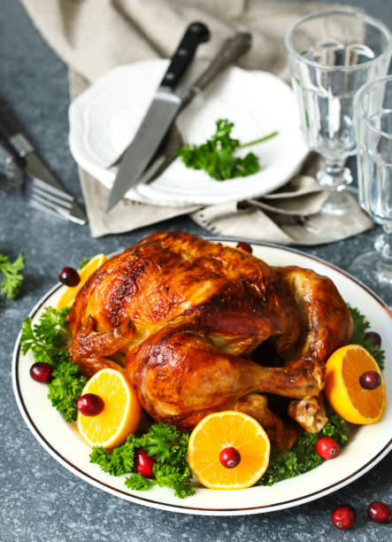istock Roasted chicken served with citrus and cranberry on plate 1090088170