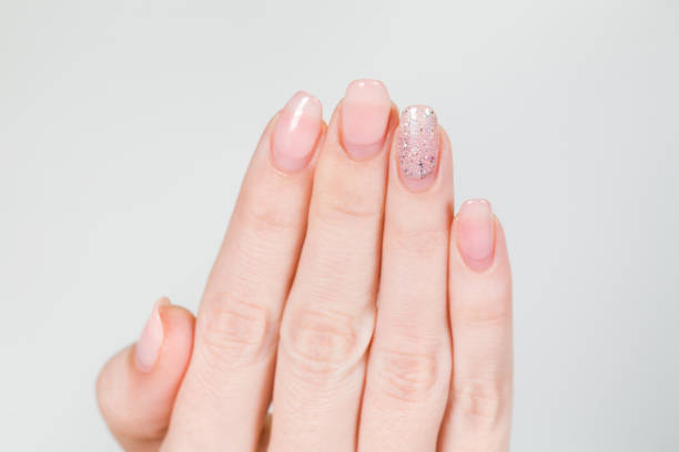 istock female white hand with old gel polished manicure need correction 1090089412