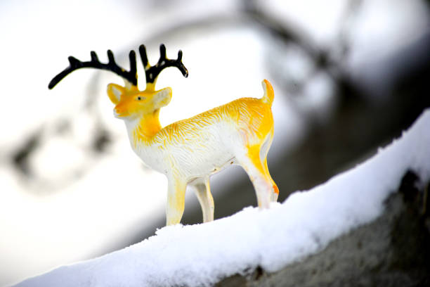deer figurine toy on a snow, winter theme, image