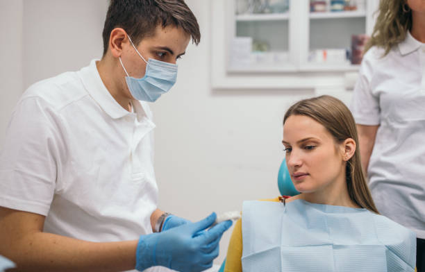 istock Dentist showing prosthetics teeth to a patient 1090097072