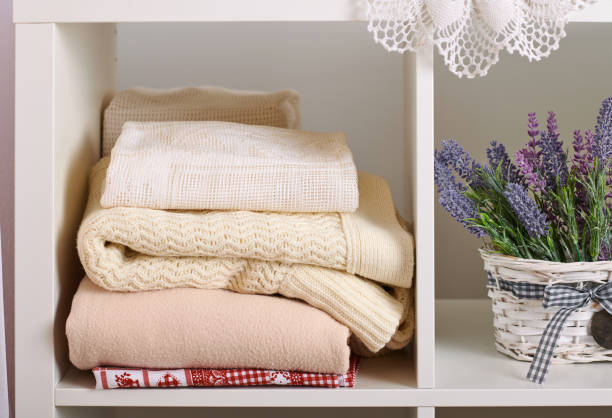 istock shelves with various things in the room - flowers, knitted blankets 1090099082