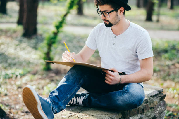 College student drawing among nature
