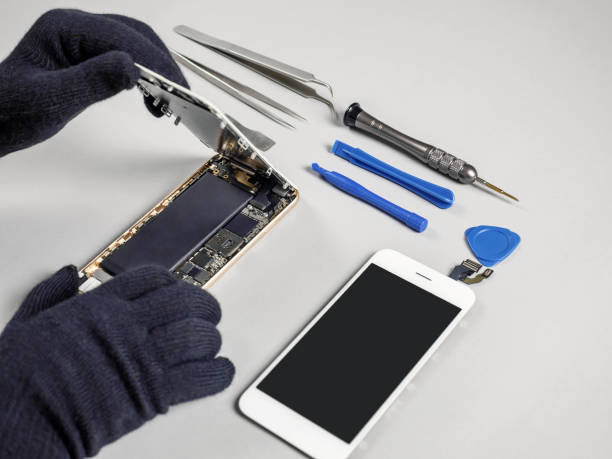 istock Technician repairing broken smartphone on desk 1090101476