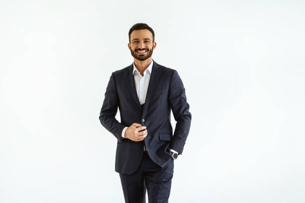 The businessman in a beautiful suit standing on the white background stock photo