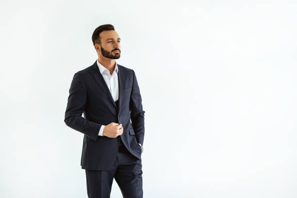 istock The man in a beautiful suit standing on the white background 1090104488