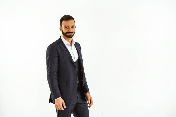 istock The businessman standing on the white wall background 1090104864