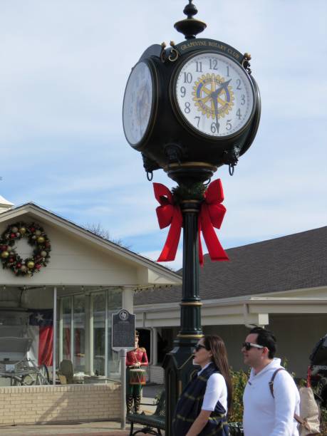 clock in Grapevine, Texas Grapevine, Texas, USA -- December 22, 2018: A historic clock on Main Street in Grapevine, a suburb city of Fort Worth and Dallas, Texas. grapevine texas city stock pictures, royalty-free photos & images
