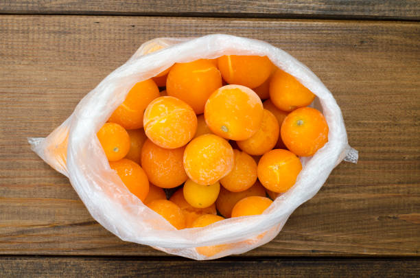 istock Frozen yellow small tomatoes in package on table. Freezing vegetables 1090105566