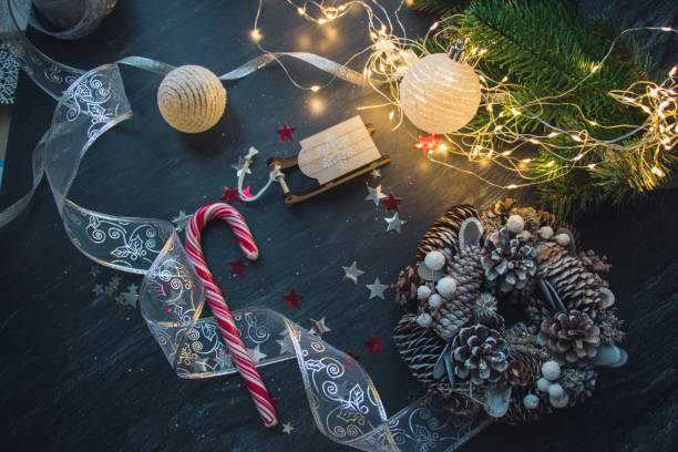 istock Christmas decorations, fur-tree branches, colorful balls, garlands, red and white glittering stars, christmas wreath on a dark background 1090107256