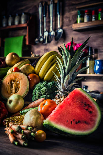 istock Organic tropical fruits and vegetables in old fashioned rustic kitchen 1090109486