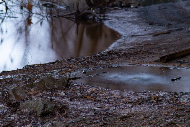 istock Puddle with dripping water on the riverbank 1090111944