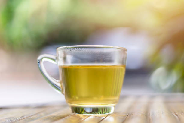 istock tea cup on wood table and sunlight at morning time. 1090112092