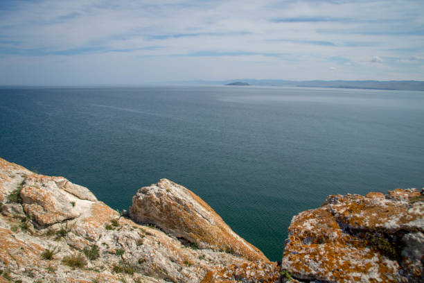 istock View at Lake Baikal over the rocks covered in lichen. 1090115688