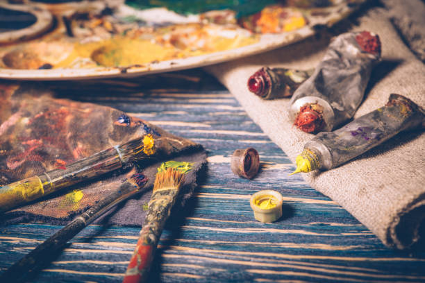 istock Old paint tubes are on the wooden table. 1090116316