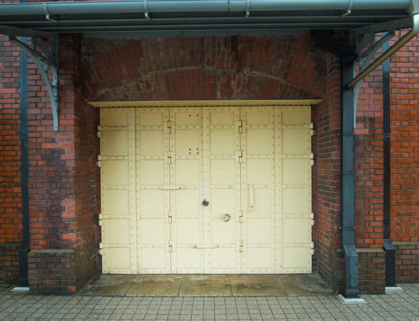Steel door on red brick wall show part of home