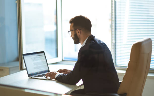 istock The businessman in glasses working with a laptop 1090124510