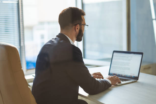 istock The businessman in glasses working with a laptop 1090124514