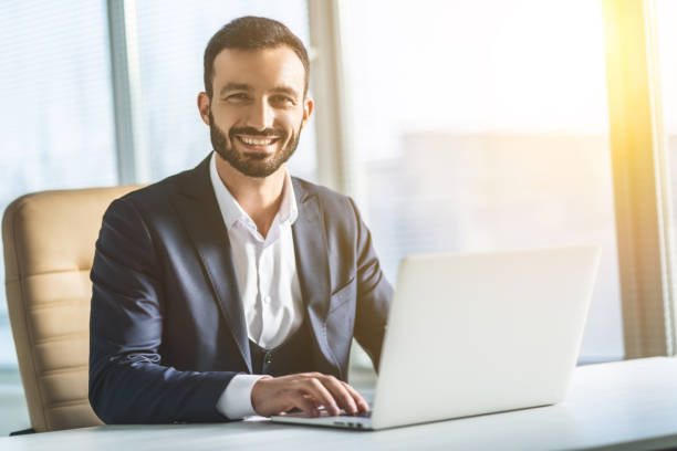 The man working with a laptop on the table