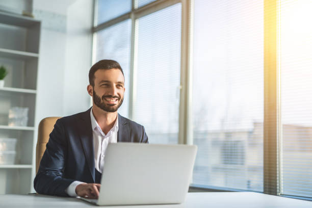 istock The man sitting at the desk with a modern laptop 1090128884