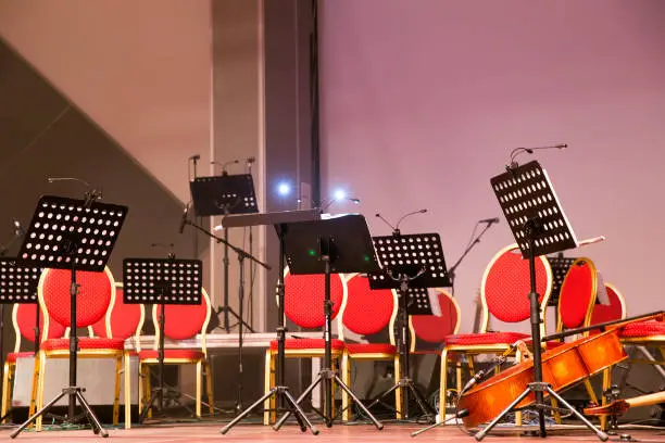 Photo of Musical instruments of symphonic orchestra and music stands for music on the concert stage