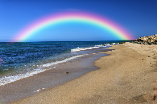 Rainbow over the tropical beach