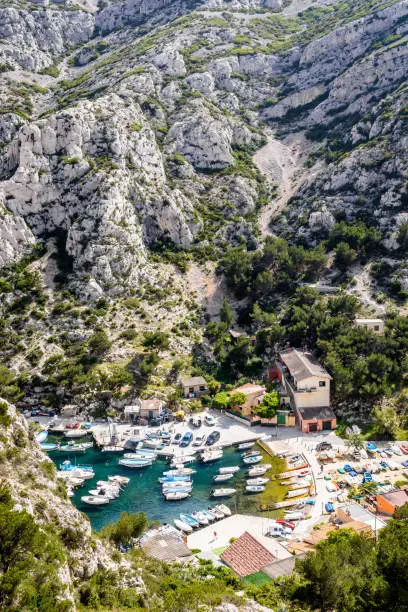High angle view over the small fishing port in the steep-sided valley of the calanque de Morgiou on the mediterranean shore between Marseille and Cassis in the south of France on a sunny spring day.