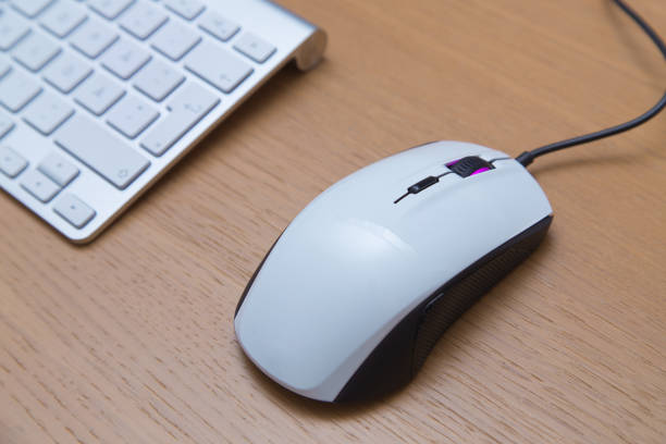 Gaming mouse and keyboard on desk stock photo