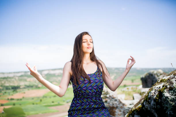 istock woman meditating in nature 1090138660