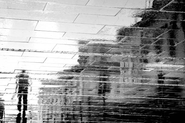 istock Blurry reflection  silhouettes of one man walking on a rainy day 1090144754
