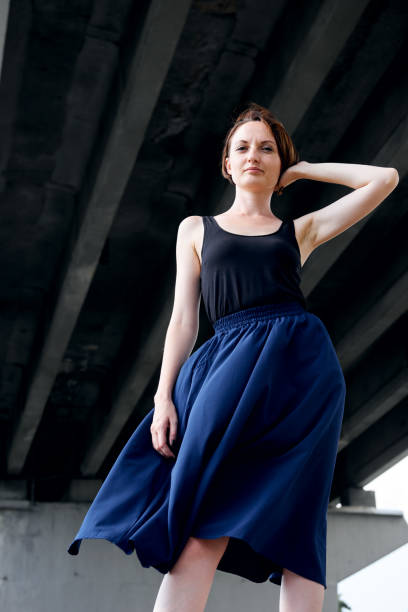 istock young girl posing under the bridge, dressed in black, modern architecture 1090145418