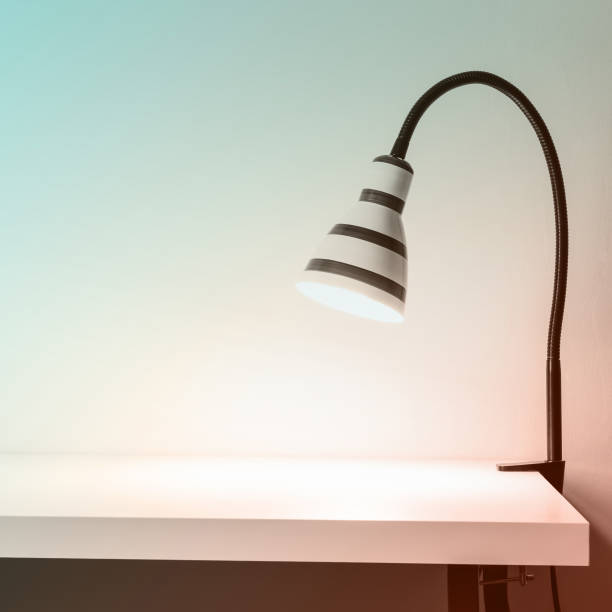 istock Luminous striped lamp on white table. White wall for mock up. Pastel toning 1090147942