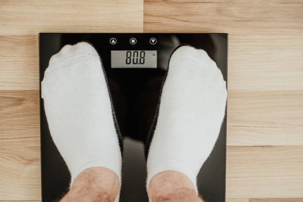 istock Top view of a man's feet on weight. 1090149680