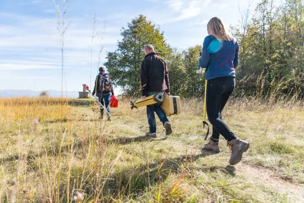 Photo of Surveyors on Their Way to a Measuring Area