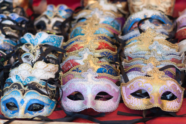 uma variedade de máscaras de carnaval colorido sobre fundo vermelho, foco seletivo - mardi gras close up veneto italy - fotografias e filmes do acervo