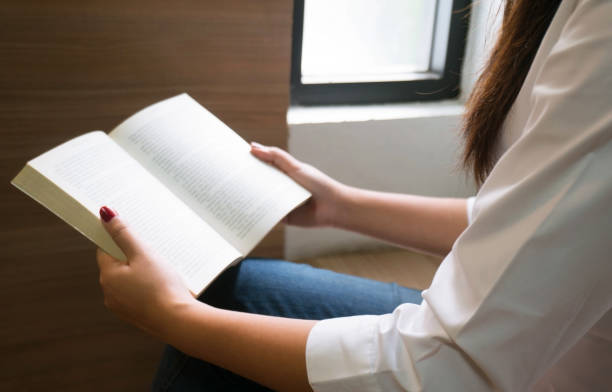 istock Women reading book and relaxing in library. selective focus 1090153696