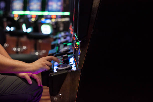 istock Adult Man Playing on Slot Machine 1090155328